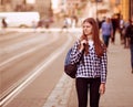 Young tourist woman with backpack walk by street in old europe city, summer fashion style Royalty Free Stock Photo