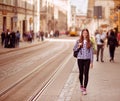 Young tourist woman with backpack walk by street in old europe city, summer fashion style Royalty Free Stock Photo