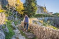 Young tourist woman enjoying a view of Kotor Bay, Montenegro. Kotor Old Town Ladder of Kotor Fortress Hiking Trail Royalty Free Stock Photo