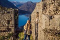 Young tourist woman enjoying a view of Kotor Bay, Montenegro. Kotor Old Town Ladder of Kotor Fortress Hiking Trail Royalty Free Stock Photo