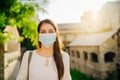 Young tourist woman with face mask travelling to European cities during coronavirus pandemic outbreak. Travel to Europe amid COVID Royalty Free Stock Photo