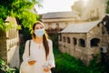 Young tourist woman with face mask travelling to European cities during coronavirus pandemic outbreak. Travel to Europe amid COVID