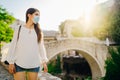 Young tourist woman with face mask travelling to European cities during coronavirus pandemic outbreak. Travel to Europe amid COVID Royalty Free Stock Photo