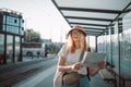 Young tourist woman hand map in outdoors at the bus stop on a city street, traveling in Europe. Tourism, destination Royalty Free Stock Photo