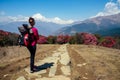 A young tourist woman with a hiking backpack and a knitted hat in the Himalaya mountains. trekking concept in the Royalty Free Stock Photo