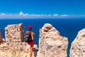 Young tourist woman look at ruins in Alanya peninsula, Antalya district, Turkey, Asia. Famous tourist destination with high Royalty Free Stock Photo