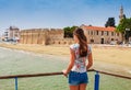 Young tourist woman looking at medieval castle in Larnaca, Cyprus Royalty Free Stock Photo