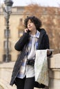 Young tourist woman with a map talking on her phone Royalty Free Stock Photo