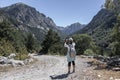 Young tourist woman take a picture from mountain with mobile phone Royalty Free Stock Photo