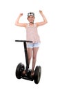 Young tourist woman wearing safety helmet rising arms up hands free smiling happy riding electrical segway