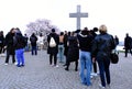 young tourists in Budapest lining up at a famous almond tree on the Gellert hill to take selfies