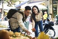 Tourists buying fruit at the street market