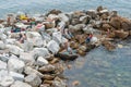 Young tourists waling along footpath in Cinque Terre Village adult tourists sunning and relaxing on pock pier in bay