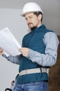 Young tradesman looking at paperwork