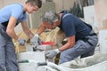 Young trainee with brick layer instructor Royalty Free Stock Photo