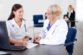 Young trainee sitting with a mature doctor