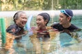 Young trainer helping senior woman in aqua aerobics and working out in the pool. old woman and mature man doing aqua aerobics Royalty Free Stock Photo