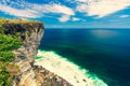 Young travel girl sits on the edge of a cliff on background amazing nature landscape tropical island Bali, Indonesia Royalty Free Stock Photo