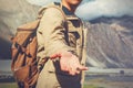 Young travel man lending a helping hand in outdoor mountain scenery Royalty Free Stock Photo