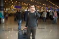 Young traveler in airport making call Royalty Free Stock Photo