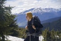 A young traveler with a backpack climbs the mountain, Royalty Free Stock Photo