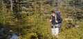 A young traveler with a backpack climbs the mountain, Royalty Free Stock Photo