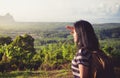 young traveler backpacker looking forward at sun to see landscape view of mountain at sunrise Royalty Free Stock Photo