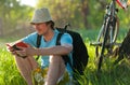 Young traveler with bicycle reading the book