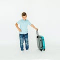 The young traveler boy with a suitcase. Isolated over white background Royalty Free Stock Photo