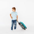 The young traveler boy with a suitcase. Isolated over white background Royalty Free Stock Photo