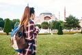 A young traveler girl with a backpack in Sultanahmet Square next to the famous Aya Sofia mosque in Istanbul in Turkey Royalty Free Stock Photo