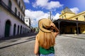 Young traveler girl walking between the palace of Pele Museum and the historic tram station, touristic Royalty Free Stock Photo