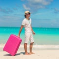 Young traveler with his luggage on a tropical beach Royalty Free Stock Photo