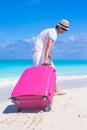 Young traveler with his luggage on a tropical beach Royalty Free Stock Photo