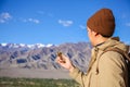 Young traveler looking at compass in Himalaya mountain view background in Leh, Ladakh, India Royalty Free Stock Photo