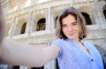 Young traveler making selfie photo standing the Colosseum in Rome Royalty Free Stock Photo