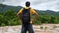 Young traveler man with backpack standing relax against landscape scenery mountain peak in phuket thailand Royalty Free Stock Photo