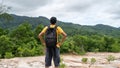 Young traveler man with backpack standing relax against landscape scenery mountain peak in phuket thailand Royalty Free Stock Photo