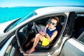 Young traveler with map sitting in the car Royalty Free Stock Photo