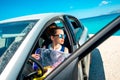 Young traveler with map sitting in the car Royalty Free Stock Photo