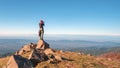 Young traveler standing on top of the cliff and taking photos