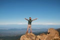Young traveler standing on top of mountain with cliff Royalty Free Stock Photo