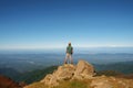 Young traveler standing on top of mountain with cliff Royalty Free Stock Photo