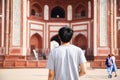 Young traveler walking towards entrance to Taj Mahal in Agra, India