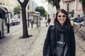 Young traveler woman admiring beautiful sunny narrow streets in Lisbon, Portugal