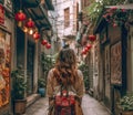Young traveler woman alone in a narrow alley trying orientate. Travel concept
