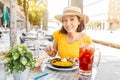 Traveler woman eating spanish dinner sea Paella and sangria fruit wine during siesta
