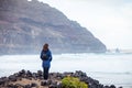 Young traveler woman enjoy ocean on black volcanic beach in Lanzarote