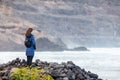 Young traveler woman enjoy ocean on black volcanic beach in Lanzarote