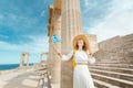 Traveler woman with greek flag at the ancient greek ruins. Tourism in Greece concept Royalty Free Stock Photo